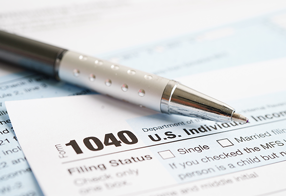 Tax form pen closeup accounting