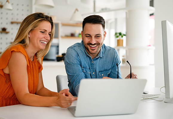 Smiling colleagues working together laptop